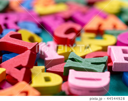 clouseup of colorful wooden alphabet on green 44544928