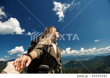Jolly woman is enjoying mountainous landscape with follower 44545282