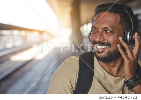 Happy hindu man wearing his modern headphones 44545723