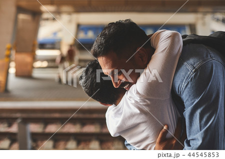 Cheerful hindu father embracing his little son 44545853