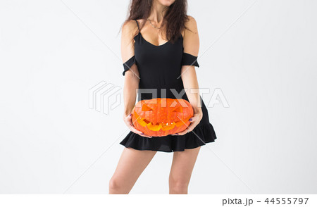 Halloween and holidays concept - Close up of witch woman with Jack O'Lantern pumpkin 44555797