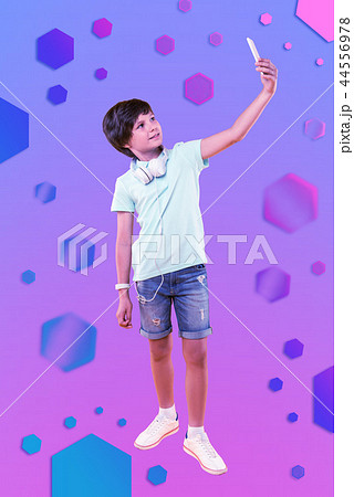 Cheerful merry boy taking selfie on background 44556978