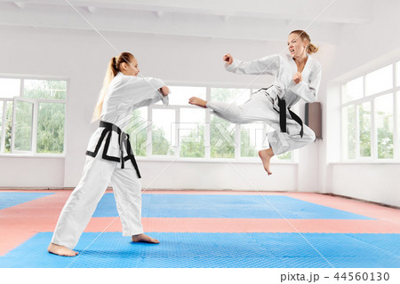 Two young women wearing in kimono and black belt training karate martial arts. 44560130