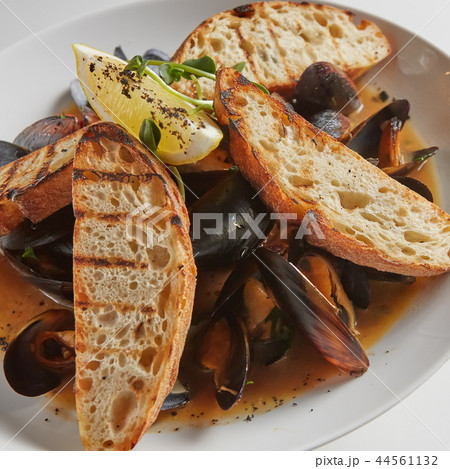 Seafood. Mussels in wine with croutons and lemon. Clams in the shells. Seafood. Mussels in wine with croutons and lemon. Clams in the shells. 44561132