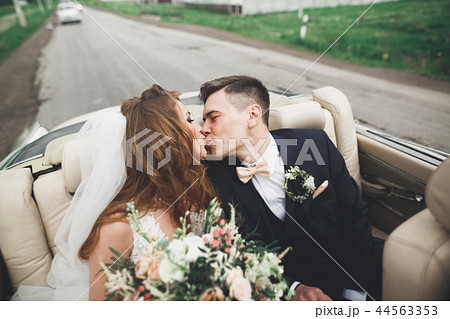 Portrait of happy newly wedding couple with bouquet 44563353