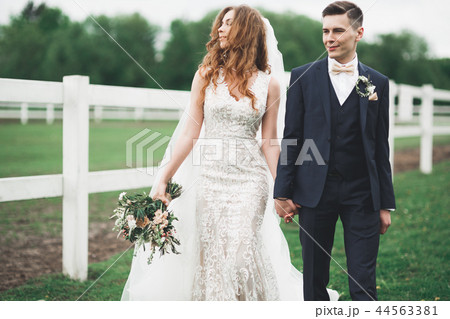 Happy bride and groom posing after wedding ceremony Happy bride and groom posing after wedding ceremony 44563381