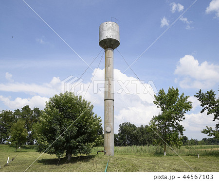 Silver Water Tower among green grass and trees Silver Water Tower among green grass and trees 44567103