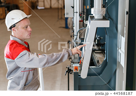 control computer display of Machine. Manufacture workers adjusts the machine in the warehouse. the 44568187