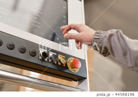 control computer display of Machine. Manufacture workers adjusts the machine in the warehouse. the 44568196