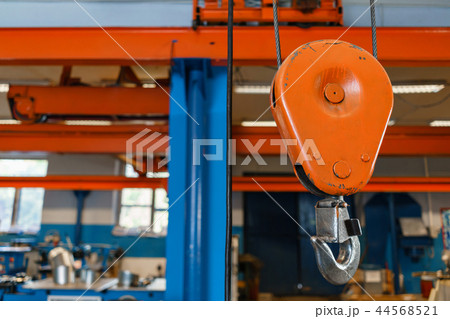 Crane hook. The system of pulleys and ropes, a hanging mechanism in the production area. Movement Crane hook. The system of pulleys and ropes, a hanging mechanism in the production area. Movement 44568521