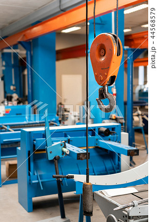 Crane hook. The system of pulleys and ropes, a hanging mechanism in the production area. Movement Crane hook. The system of pulleys and ropes, a hanging mechanism in the production area. Movement 44568579