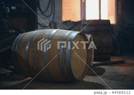 Wooden barrels in the old cellar in winery. barrels for wine with steel ring 44569112