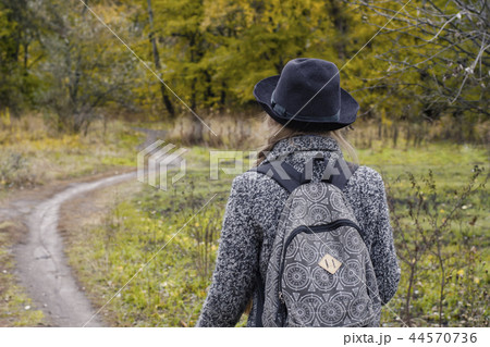 Girl with a backpack and a hat standing Girl with a backpack and a hat standing 44570736