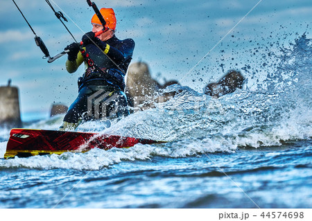A male kiter slides on the surface of the water. A male kiter slides on the surface of the water. 44574698