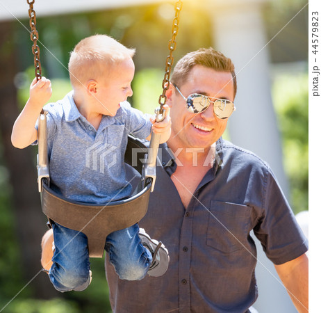 Young Boy Having Fun With His Father At The Park Young Boy Having Fun With His Father At The Park 44579823