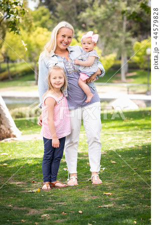 Caucasian Mommy and Daughters Portrait In The Park 44579828