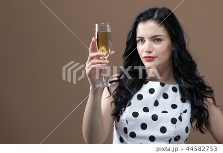 Young woman holding a champagne flute Young woman holding a champagne flute 44582753