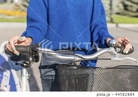 Female hands on the handlebars Female hands on the handlebars 44582884