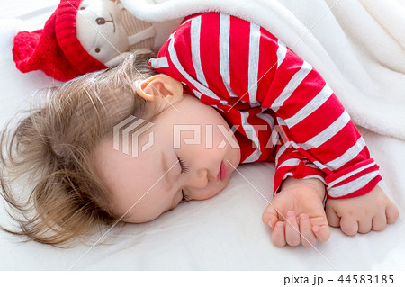 Toddler boy sleeping in his house at Christmas time Toddler boy sleeping in his house at Christmas time 44583185