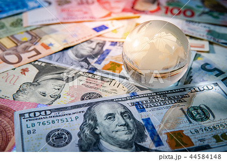 World globe crystal on various banknotes 44584148