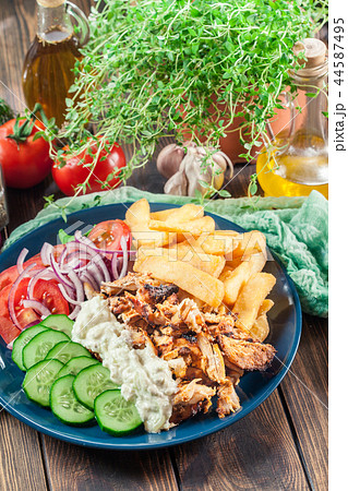 Greek gyros dish with french fries and vegetables 44587495