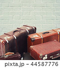 The old suitcases on brick wall background 44587776