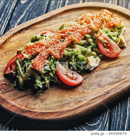 Red fish with sesame on vegetables On the black wooden table 44590674