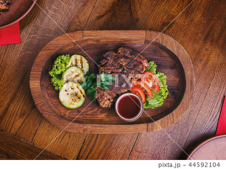 Hot steak with sauce and vegetables. Snacks for beer at the pub Hot steak with sauce and vegetables. Snacks for beer at the pub 44592104