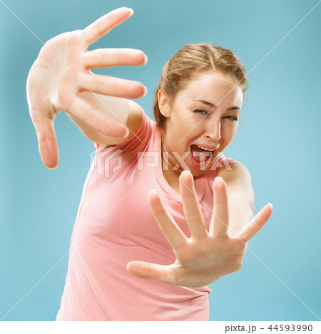 Portrait of the scared woman on blue 44593990