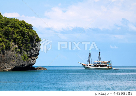 White sailboat in the ocean with island views  44598505