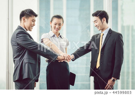 Businesspeople stacking each other's hand 44599803