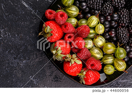 Image on top of blackberries, strawberries, raspberries, gooseberries on black plate Image on top of blackberries, strawberries, raspberries, gooseberries on black plate 44600056