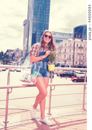 Caring loving daughter holding beautiful home plant after shopping day Caring loving daughter holding beautiful home plant after shopping day 44600684