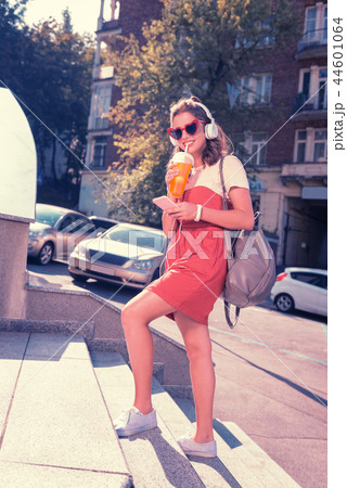 Young fashionable student entering university with her stylish grey backpack Young fashionable student entering university with her stylish grey backpack 44601064