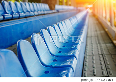 Empty plastic chairs in the stands of the stadium Empty plastic chairs in the stands of the stadium 44603364