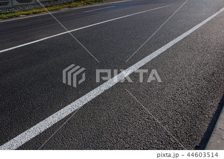 Asphalt road with marking lines white stripes Asphalt road with marking lines white stripes 44603514