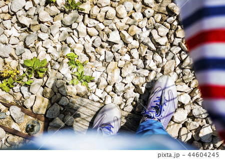 Travel theme legs in shoes walking old rail road Travel theme legs in shoes walking old rail road 44604245
