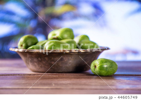 Fresh green mini baby kiwi fruit with palm beach 44605749