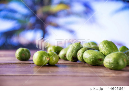 Fresh green mini baby kiwi fruit with palm beach 44605864