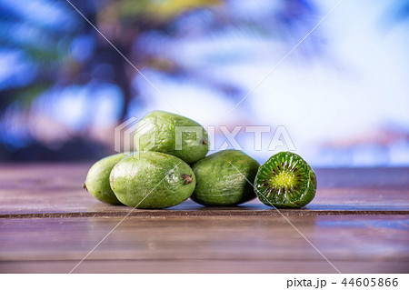 Fresh green mini baby kiwi fruit with palm beach Fresh green mini baby kiwi fruit with palm beach 44605866