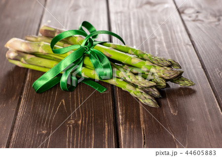 Fresh green asparagus spear on brown wood Fresh green asparagus spear on brown wood 44605883