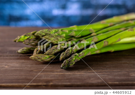 Fresh green asparagus spear on brown wood Fresh green asparagus spear on brown wood 44605912