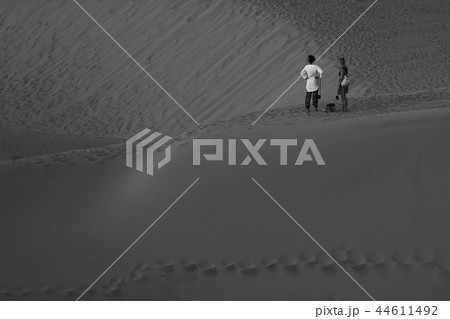 A people walking in the desert 44611492