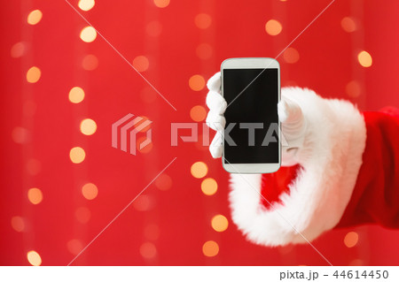 Santa holding a smartphone 44614450