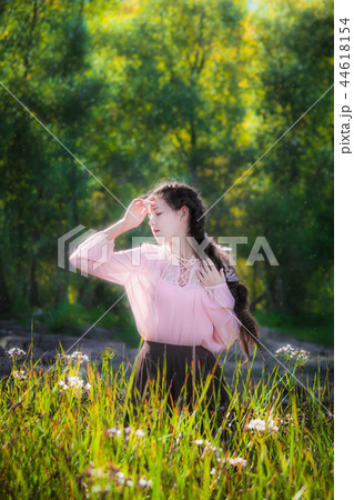 Dreamy girl on a summer sunny day walking in field Dreamy girl on a summer sunny day walking in field 44618154
