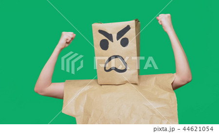 concept of emotion, gestures. a man with a package on his head, with a painted smiley aggressive concept of emotion, gestures. a man with a package on his head, with a painted smiley aggressive 44621054