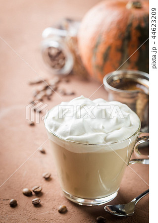 Pumpkin latte with whipped cream 44623209