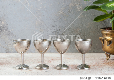 Vintage four silver goblet and green plants 44623840