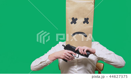 concept of emotion, gestures. a man with a package on his head, with a painted smiley, exhausted 44627375