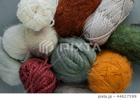 Variety of knitting yarns on grey background. Variety of knitting yarns on grey background. 44627599